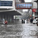 Vehicles navigate through inundated Poonch Road as daily life is disrupted following torrential rains in the provincial capital