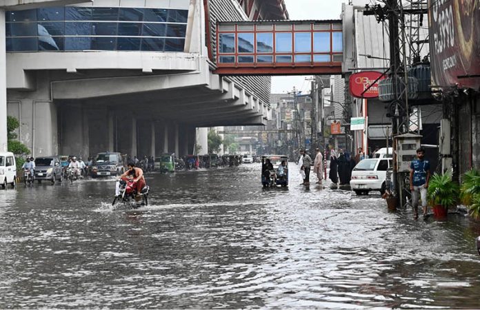 Vehicles navigate through inundated Poonch Road as daily life is disrupted following torrential rains in the provincial capital