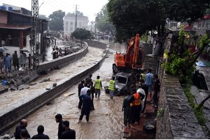 A view of damaged cars being recovered from a nullah in Saidpur Village due to flooding caused by heavy rainfall in the Federal Capital.