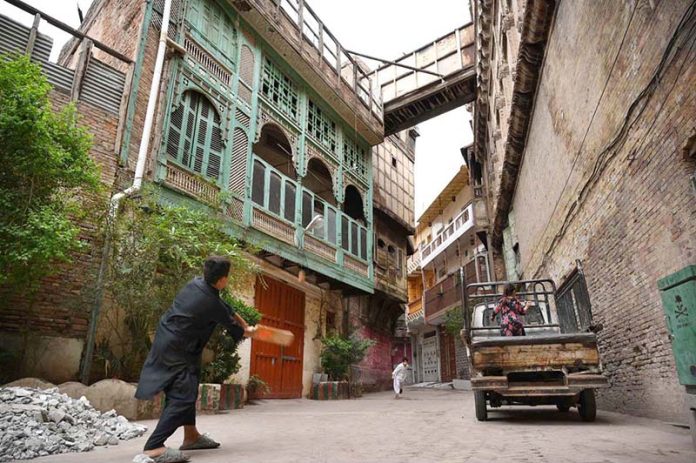 People play cricket in Mohalla Sethian, located in the heart of Peshawar’s old walled city, where seven historic havelis—architectural gems of the 18th and 19th centuries once owned by the Sethi merchant family—now stand in neglect