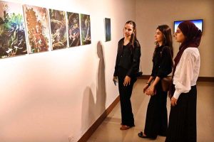 Visitors and art enthusiasts keenly observe artworks on display at the inaugural exhibition titled "Seeing", curated by Sarah Rajper at PNCA