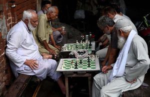 Local residential People playing the Chess game on the roadside street near Lakshami chowk during evening time in the Provincial Capital.