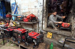 A mechanic repairs batteries at his roadside workshop near Charsadda Road.