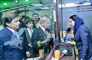 Prime Minister Muhammad Shehbaz Sharif interacts with information desk staff at Lahore Railway Station.
