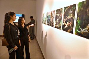Visitors and art enthusiasts keenly observe artworks on display at the inaugural exhibition titled "Seeing", curated by Sarah Rajper at PNCA