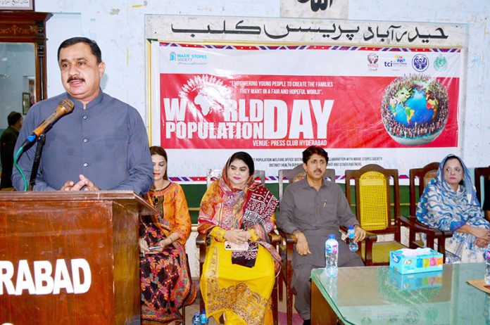 District Health Officer Pir Ghulam Hussein addresses a gathering on World Population Day, organized by the Population Welfare Department of Sindh at the Press Club