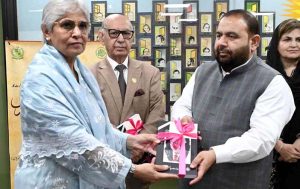Chairperson Pakistan Academy of Letters, Dr. Najeeba Arif presents a book Adbiat to Federal Minister for National Heritage and Culture, Aurangzeb Khan Khichi during a special session in memory of the well-known writer Patras Bukhari at Academy of Letters.