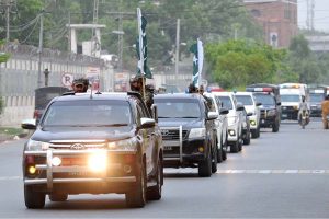 A view of security officials holding a flag march to develop a sense of protection among the masses and maintain law and order during the holy month of Muharram-ul-Haram