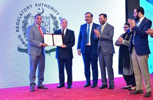 Prime Minister Muhammad Shehbaz Sharif presents the first digitally issued medical licence to the CEO of Kwik Test Private Ltd., at the inaugural ceremony of the digital system for licensing and registration of medical devices.