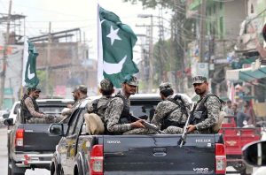 A view of security officials holding a flag march to develop a sense of protection among the masses and maintain law and order during the holy month of Muharram-ul-Haram