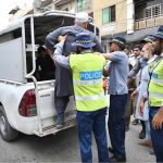 Traffic police officials arrest a man during an anti-encroachment operation in the Namak Mandi area