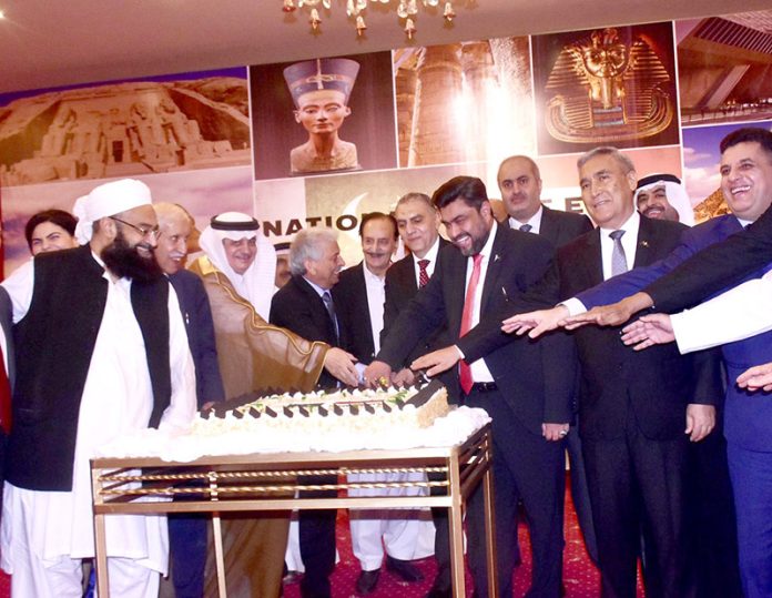 Federal Minister for National Food Security & Research, Rana Tanveer Hussain cutting a cake to celebrate the National Day ceremony of the Arab Republic of Egypt
