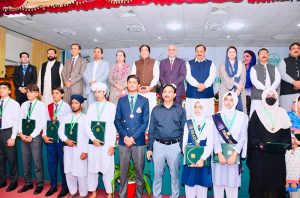 Federal Minister for Railways Muhammad Hanif Abbasi in a group photo with top position-holding students during an award ceremony at Fatima Jinnah Women University, where BISE Rawalpindi honored the high achievers
