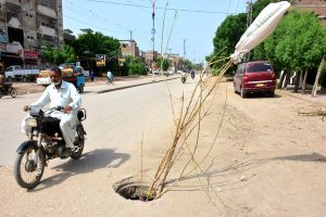 A view of sewerage manhole open on the main road at Latifabad needs the attention of the concerned authorities