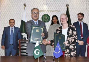 Dr. Kazim Niaz, Secretary Economic Affairs, and EU Ambassador, Dr. Riina Kionka, shaking hands after signing grant agreement between Pakistan and European Union