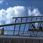 Labourers are busy paint the overhead pedestrian bridge on the Islamabad Expressway as in the background beautiful view of clouds hovering over the sky of Federal Capital