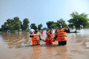 Rescue 1122 personnel evacuate residents from flood-hit areas to safer locations after the River Chenab overflowed, as rising water levels triggered by heavy rains and the opening of Indian floodgates crossed the danger mark.
