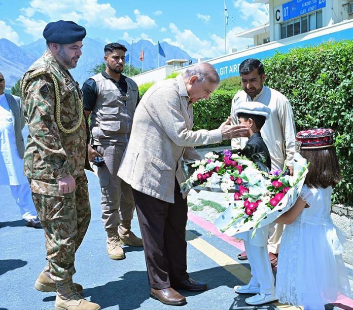 Prime Minister Muhammad Shehbaz Sharif being presented a floral bouquet at Gilgit Airport upon his arrival in Gilgit-Baltistan on his day long visit