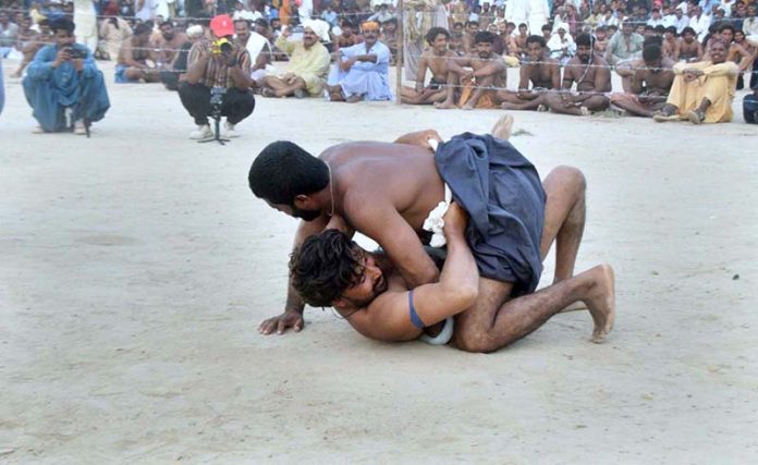 Wrestlers in action in traditional wrestling (Malakhra) during 282nd urs celebration of Hazrat Shah Abdul Latif Bhitai
