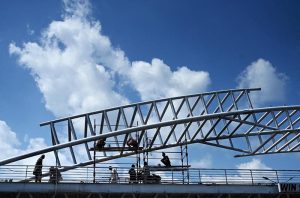 Labourers are busy paint the overhead pedestrian bridge on the Islamabad Expressway as in the background beautiful view of clouds hovering over the sky of Federal Capital