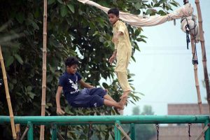 Youngsters enjoy jumping on a trampoline.