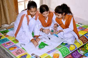 Students busy creating paintings during the 78th Independence Day Marka-e-Haq celebration painting competition at a local school.