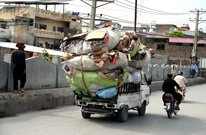 An overloaded pickup van carrying cardboard at Khayaban area in the city poses a risk of accidents and needs the attention of the concerned authorities