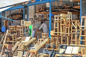 A carpenter busy in preparing different wooden stools at his workplace in a local market. APP/ADZ/MAF/TZD