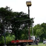 Workers busy repairing a traffic signal pole in the federal capital