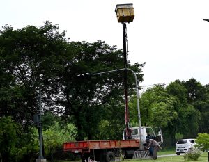 Workers busy repairing a traffic signal pole in the federal capital