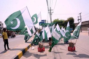 A vendor displays national flags at his roadside stall ahead of the 78th Independence Day celebrations.