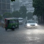 Vehicles make their way through heavy rain in the Provincial Capital