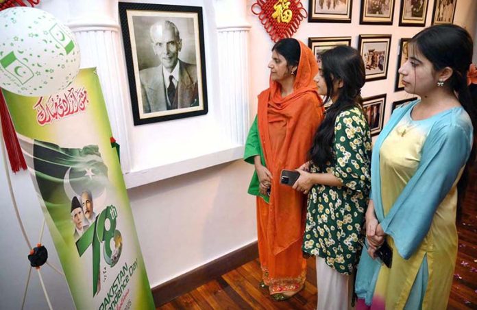 Visitors keenly viewing Quaid-e-Azam pictures during the Independence Day ceremony organized by China Window