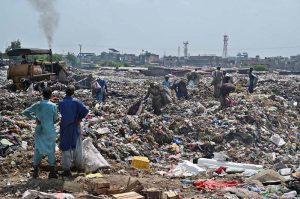 A large number of gypsy people searching valuables from heap of garbage near I-11 in Federal Capital.