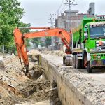 A view of construction work of sewerage nala with help of heavy machine during development work in the city at Sehrish nagar.