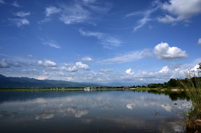 A picturesque view of clouds reflecting in the water at Rawal Dam in the Federal Capital