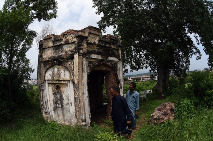 A view of the historic Kuri Baradari located at Kuri Village, believed to have been built during the reign of Maharaja Ranjit Singh (1799–1840). The octagonal structure, set on an elevated plinth, features foliated pillars, arched entrances from four directions, and a staircase of eleven steps on its eastern side. Traces of Sikh-era frescoes—depicting Guru Nanak with companions Bala and Mardana—can still be seen on its inner and outer walls, despite defacement and deteriorating plaster. The ceiling remains adorned with fading floral designs and a Gurmukhi inscription is visible on the western outer panel