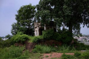 A view of the historic Kuri Baradari located at Kuri Village, believed to have been built during the reign of Maharaja Ranjit Singh (1799–1840). The octagonal structure, set on an elevated plinth, features foliated pillars, arched entrances from four directions, and a staircase of eleven steps on its eastern side. Traces of Sikh-era frescoes—depicting Guru Nanak with companions Bala and Mardana—can still be seen on its inner and outer walls, despite defacement and deteriorating plaster. The ceiling remains adorned with fading floral designs and a Gurmukhi inscription is visible on the western outer panel