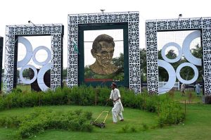 A gardener busy trimming grass along the Expressway greenbelt in the Federal Capital