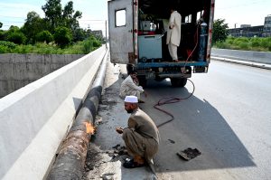 A welder is busy welding a newly installed pipeline at the 10th Avenue flyover as part of ongoing development work in the Federal Capital