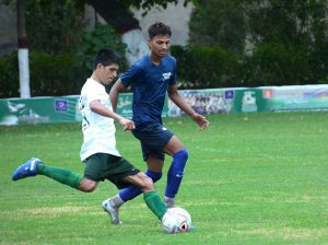 Players of Faisalabad Blue and Faisalabad White in action during a football match held under the Independence Day & Marka-e-Haq Sports Competition at Divisional Public School & College ground.