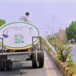 PHA staffer busy watering plants along the greenbelt at old Shujabad Road