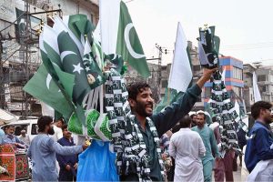 Young vendors displaying and selling national flags at Ganpat Road in the provincial capital ahead of the upcoming Independence Day celebrations