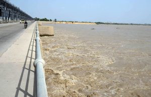 Fishermen catching the fish on their boats after rising water level in Indus river at kotri barrage, caused by ongoing heavy monsoon rains across the country