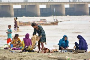 Children diving into the Indus River for swimming after rising water levels caused by heavy monsoon rains. Experts advise caution to avoid any mishap.
