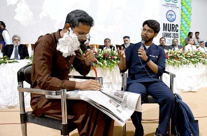 Students perform a tableau during the Workshop and Medical Undergraduate Research Conference organized by Liaquat University of Medical & Health Sciences (LUMHS), Jamshoro