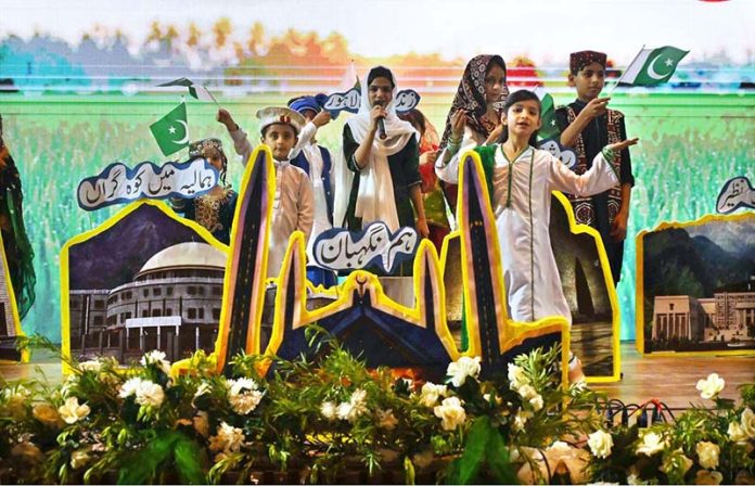 Students singing a national song during the Marka-e-Haq and 78th Independence Day celebrations organized by the Workers Welfare Fund at the National Library Auditorium