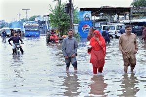 Motorcyclists are wades through floodwaters at Jail Road after heavy rainfall in the city