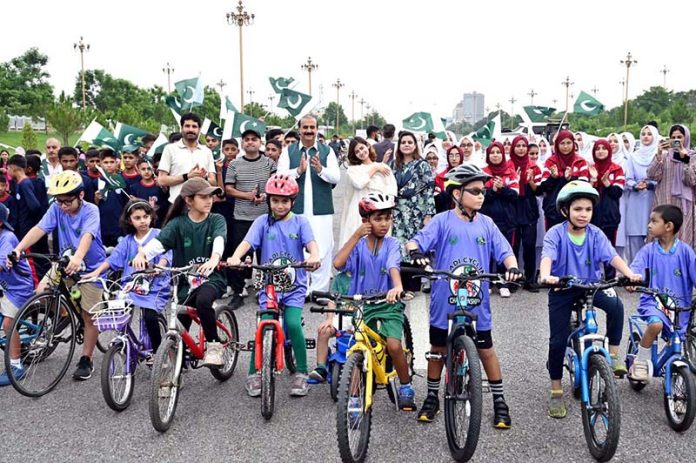 Participants taking part in Azadi Cycling Championship organized by the Directorate of Municipal Administration and Sports Directorate CDA at D-Chowk in the Federal Capital