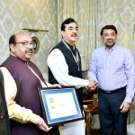 A special award is being presented to Chairman Senate Syed Yousuf Raza Gillani by Mian Salman Mubarak on behalf of Award Roots International.